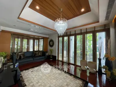 Luxurious living room with elegant chandelier and wooden accents