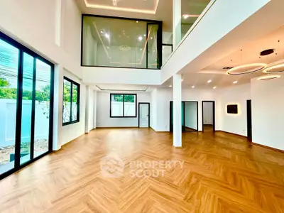 Spacious modern living room with high ceilings and elegant wood flooring