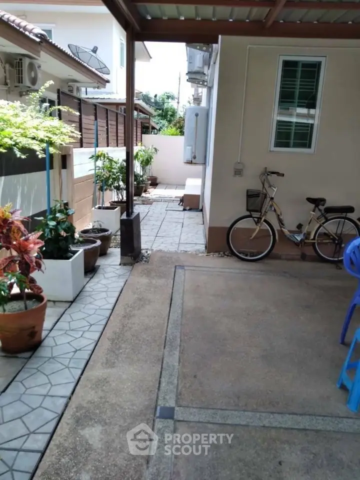 Charming residential exterior with bike and garden path, perfect for outdoor relaxation.