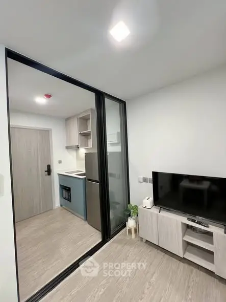 Modern compact living room with open kitchen and sleek design