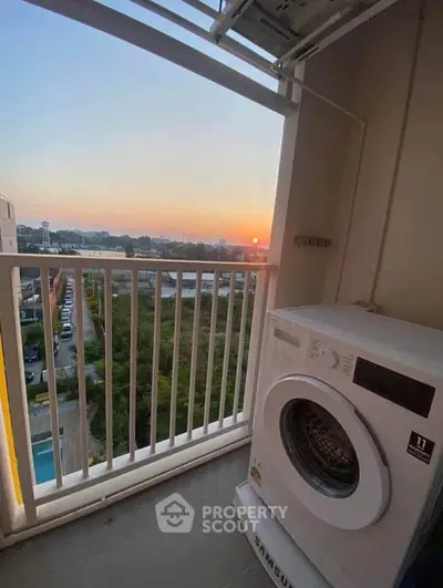 Charming balcony with sunset view and washing machine, perfect for urban living.