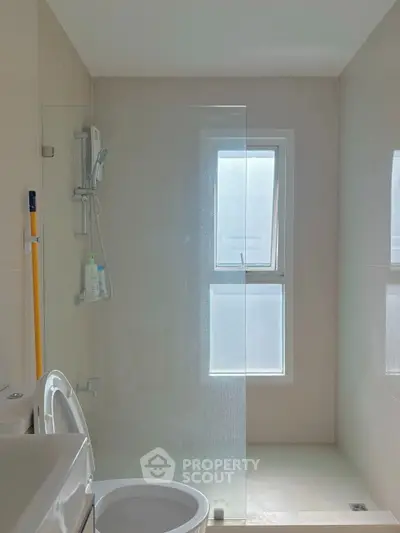 Modern bathroom with glass shower and natural light