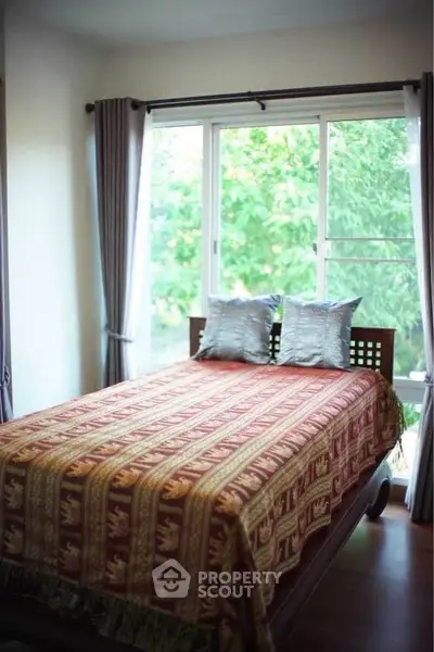 Cozy bedroom with large window and elegant decor