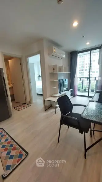 Modern apartment interior with open living area and balcony view