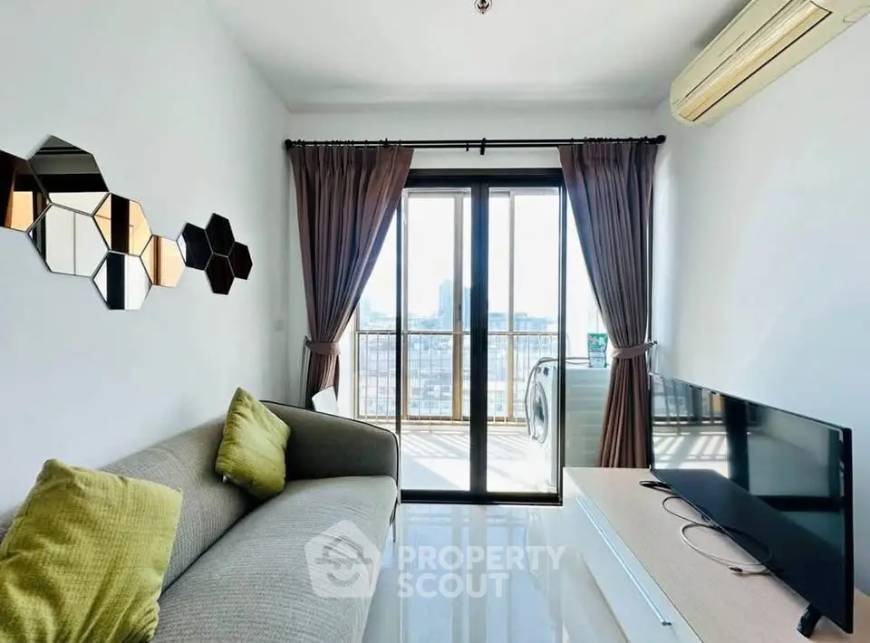 Modern living room with balcony view, stylish decor, and natural light.