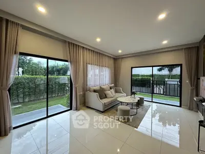 Spacious modern living room with large windows and garden view