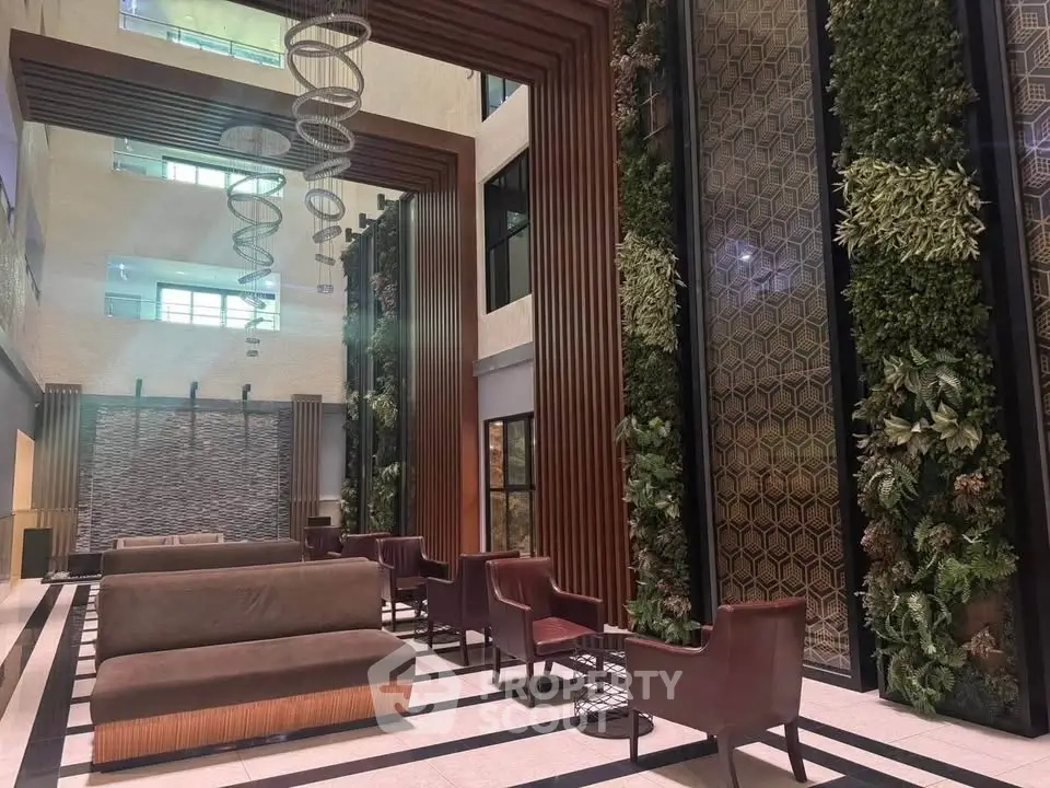 Luxurious modern building entrance with stylish seating and vertical garden walls.