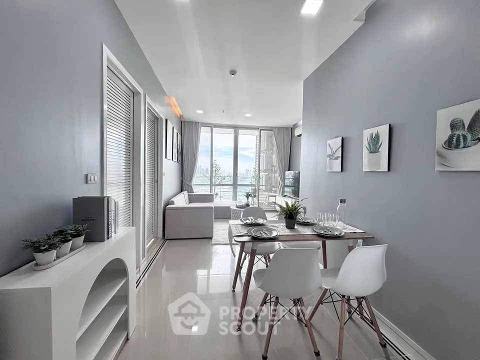 Modern living room with dining area and city view, featuring sleek furniture and stylish decor.