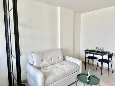Modern living room with cozy white sofa and stylish dining area