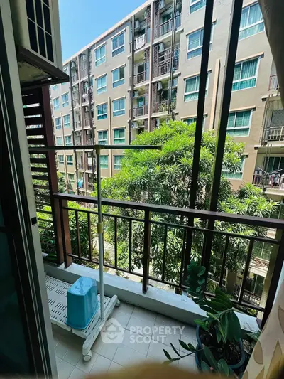 Charming balcony view with lush greenery in modern apartment complex