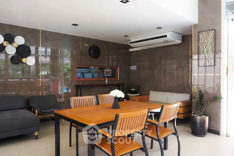 Modern common area with stylish furniture and air conditioning in a contemporary building.