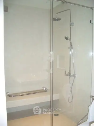 Modern bathroom with glass shower enclosure and sleek fixtures