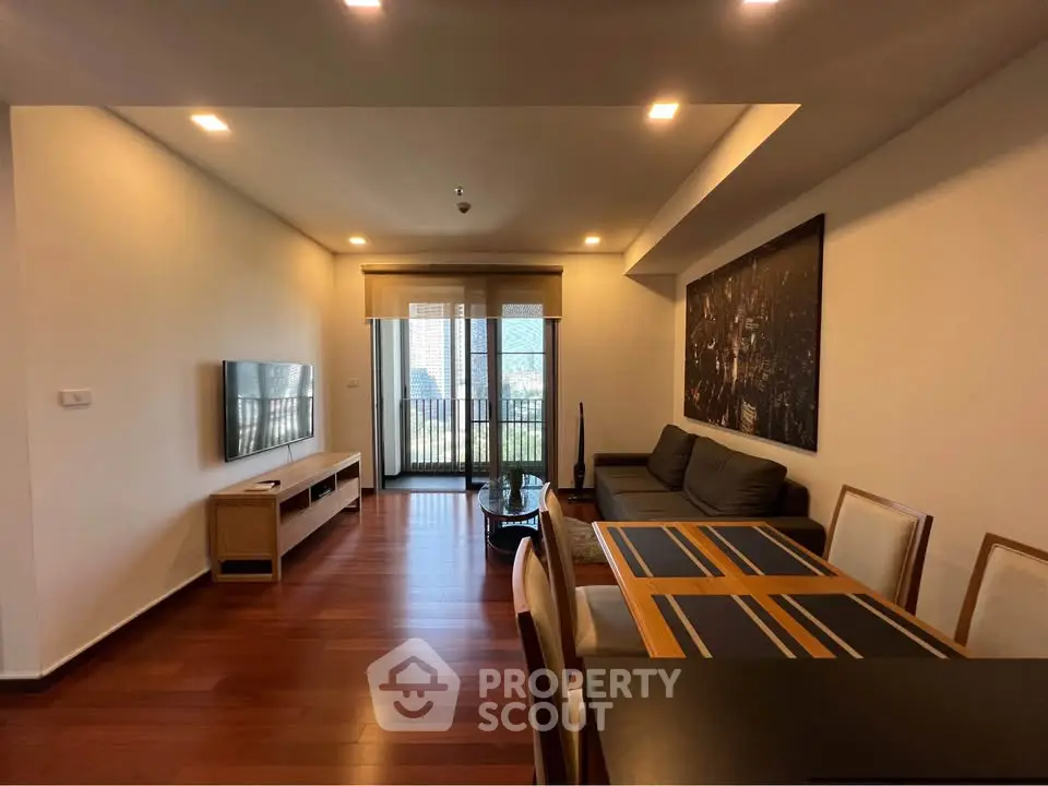 Spacious living room with modern decor and balcony view in luxury apartment.