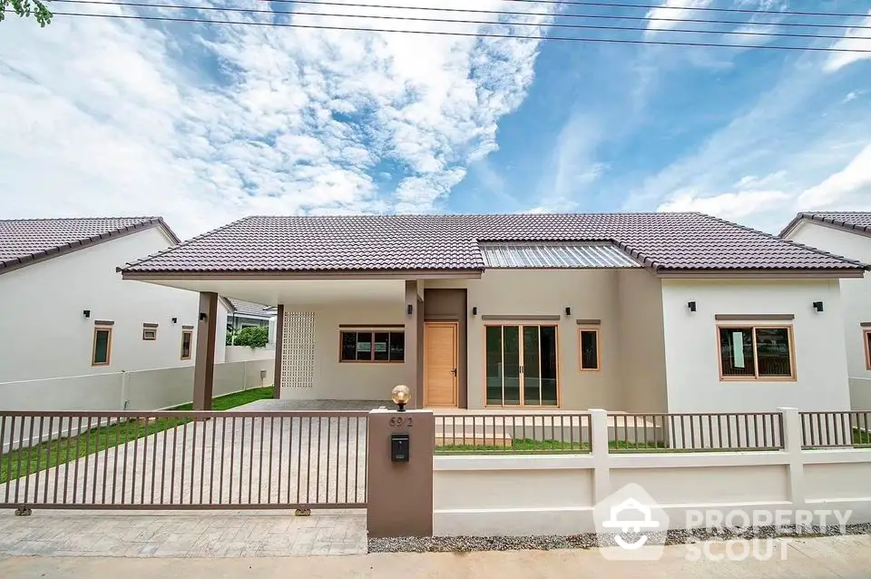 Modern single-story house with spacious driveway and elegant facade