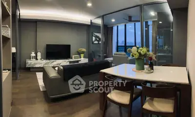 Modern living room with stylish decor and city view, featuring sleek furniture and elegant lighting.
