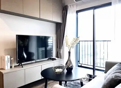 Modern living room with sleek TV setup and balcony view