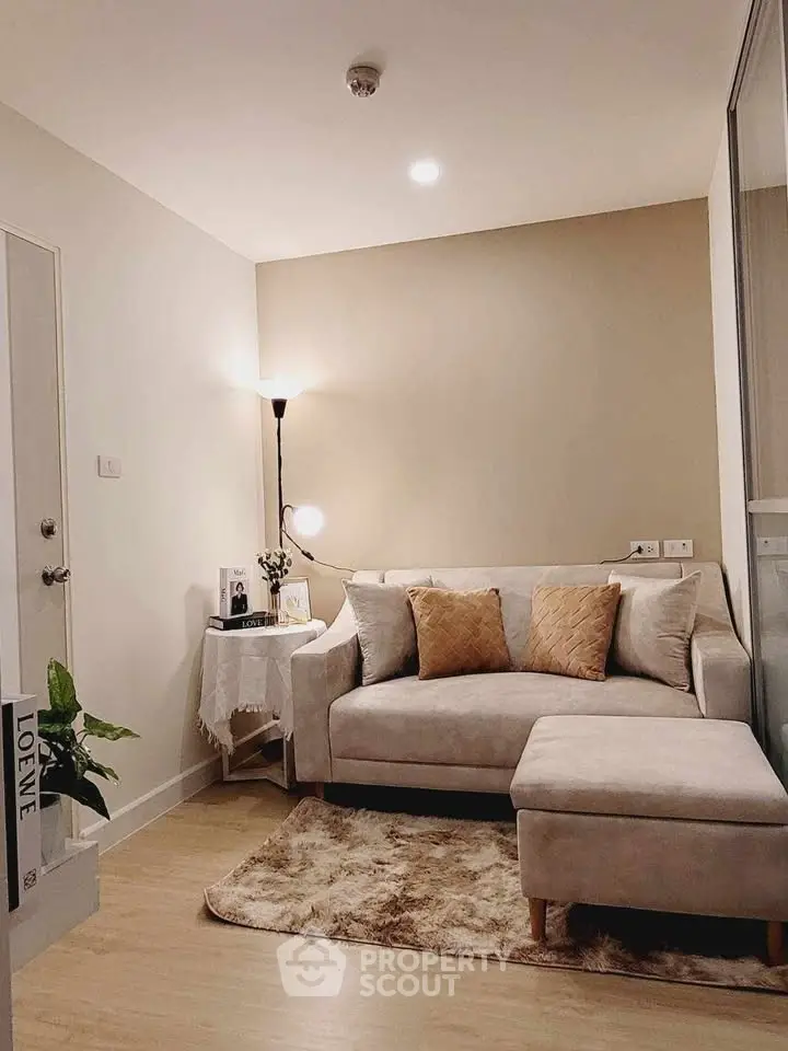 Cozy living room with plush sofa and warm lighting in modern apartment