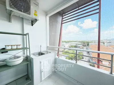 Spacious balcony with sink and storage, offering stunning city views.