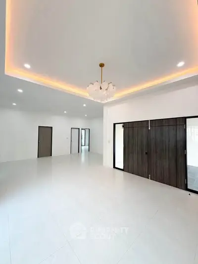 Spacious modern living room with elegant lighting and sliding doors
