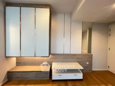 Modern bedroom with sleek built-in storage and wooden flooring