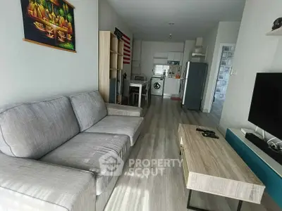 Modern living room with open kitchen layout and stylish decor