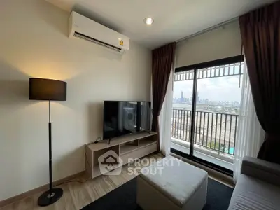 Modern living room with city view, featuring sleek furniture and large windows for natural light.