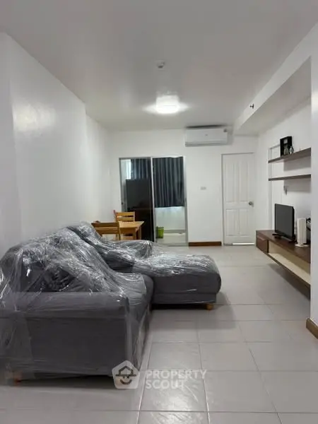 Modern living room with sleek furniture and natural light, perfect for relaxation and entertainment.
