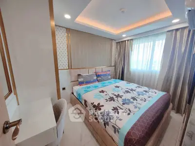 Luxurious bedroom with elegant decor and large window offering natural light.