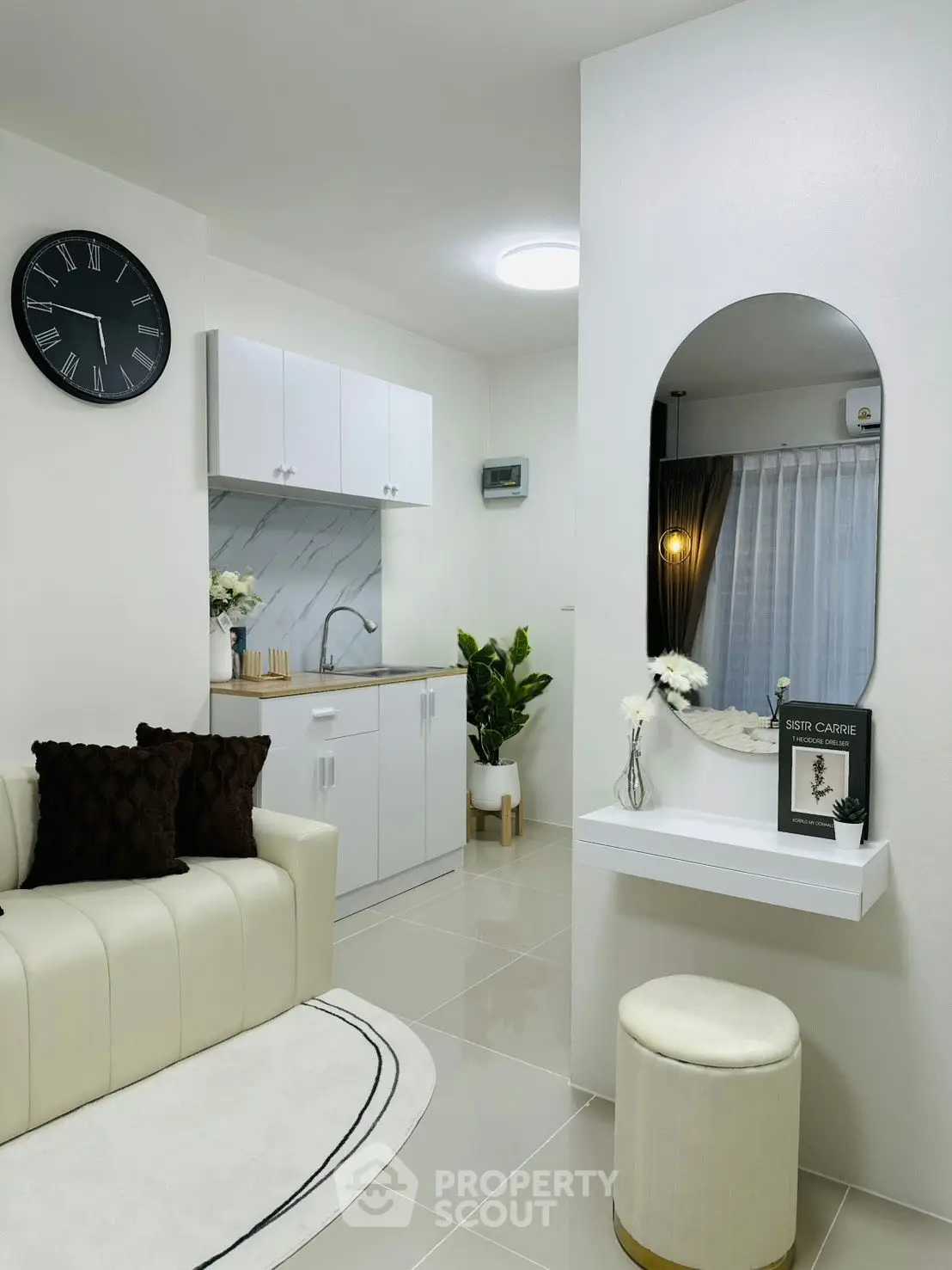 Modern living room with sleek kitchen, elegant decor, and stylish furniture in a cozy apartment.