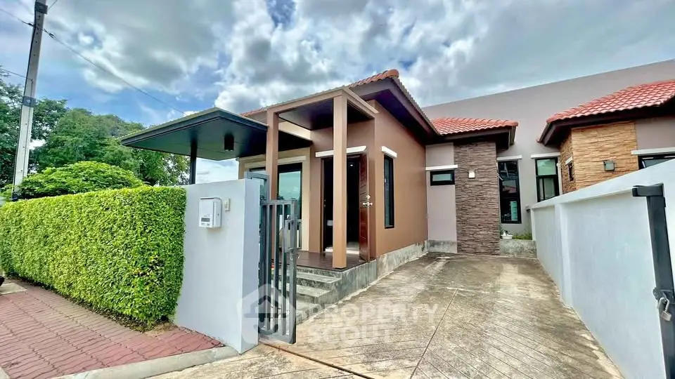 Charming modern house with red-tiled roof and lush greenery, perfect for family living.
