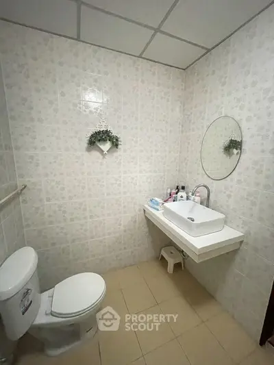 Cozy bathroom with modern fixtures and floral wall decor