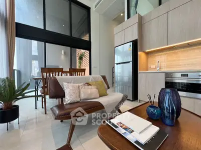 Modern open-plan living area with stylish furniture and kitchen appliances