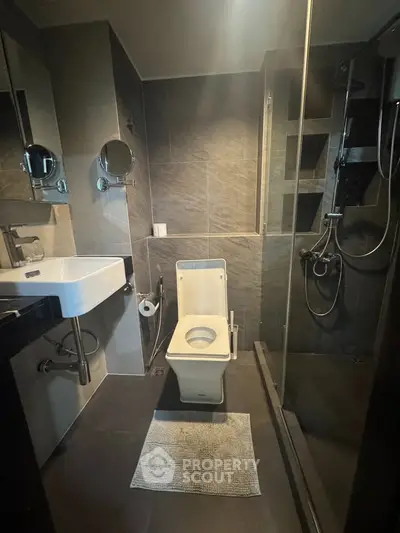 Modern bathroom with sleek fixtures and glass shower enclosure