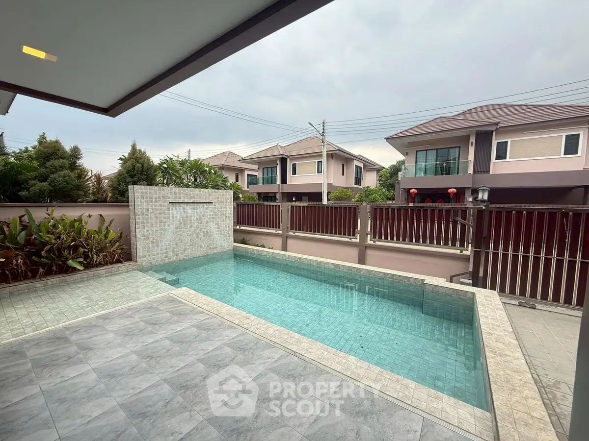 Modern home with private pool and spacious patio in serene neighborhood.