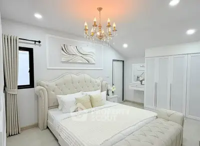 Luxurious bedroom with elegant chandelier and plush furnishings
