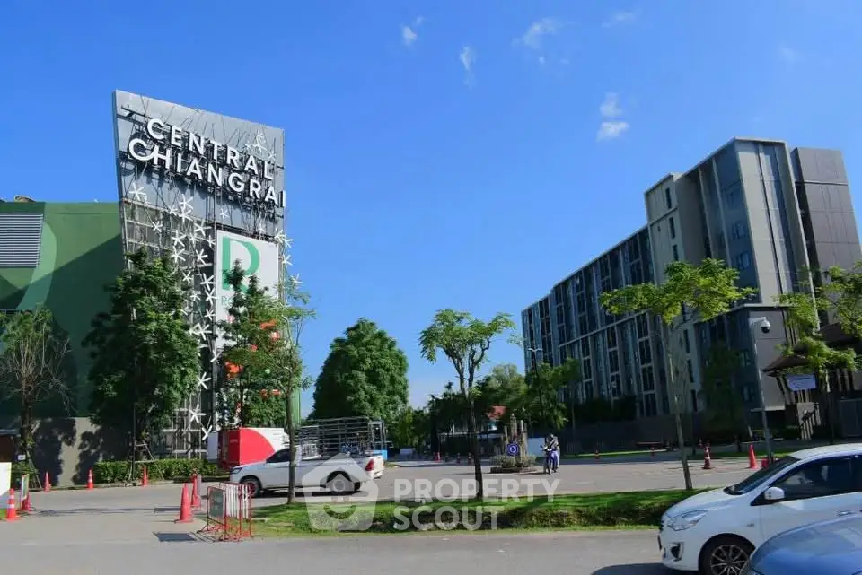 Modern building exterior with lush greenery and clear blue sky in Chiang Rai.