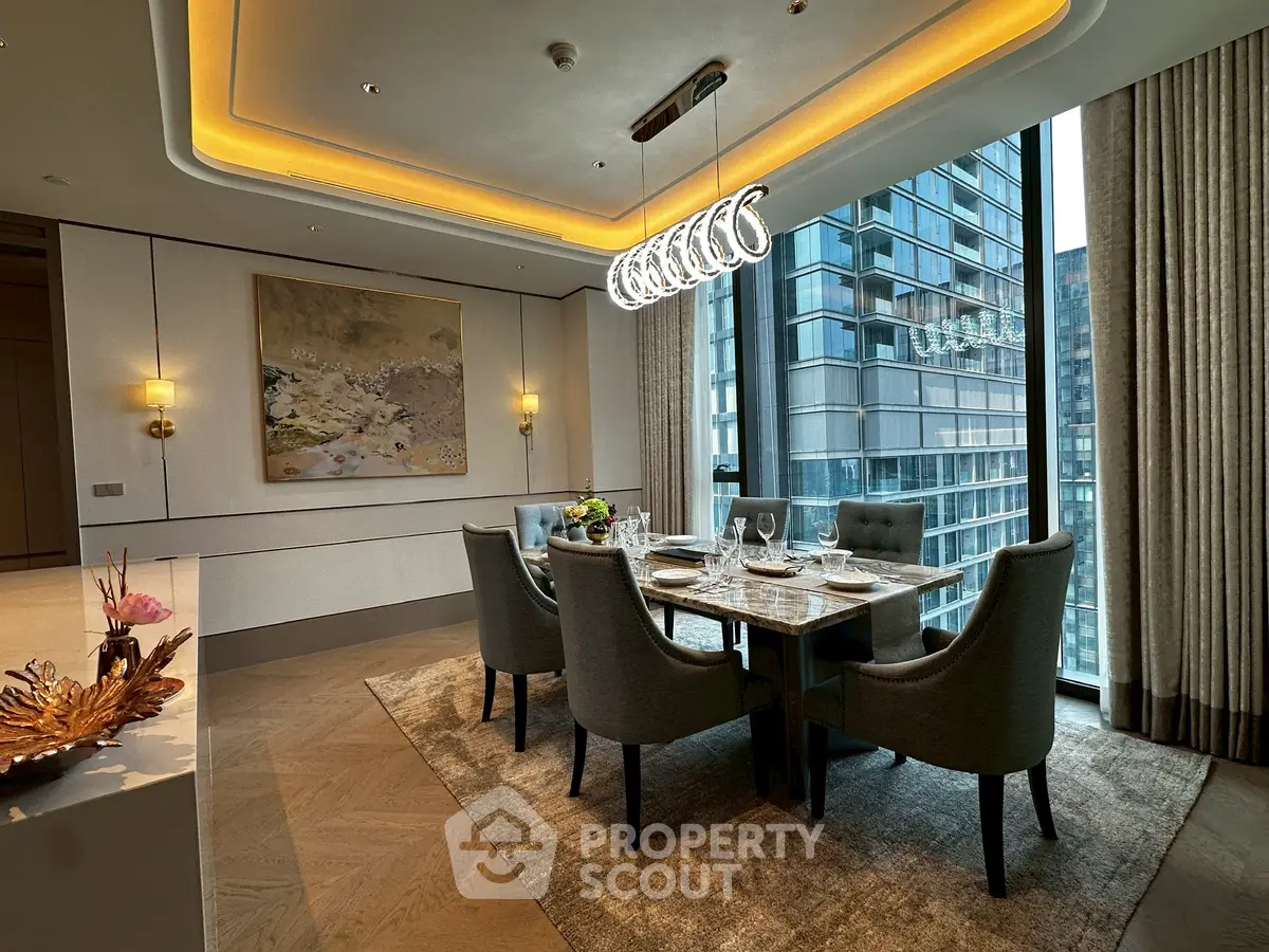 Luxurious dining room with elegant decor and city view, featuring modern lighting and sophisticated furnishings.