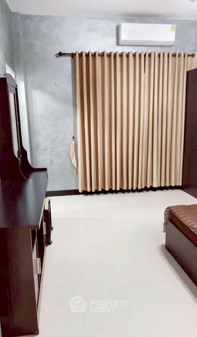 Spacious living room with modern furniture and air conditioning