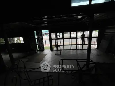 Spacious commercial space with large windows and open layout, ideal for retail or office use.