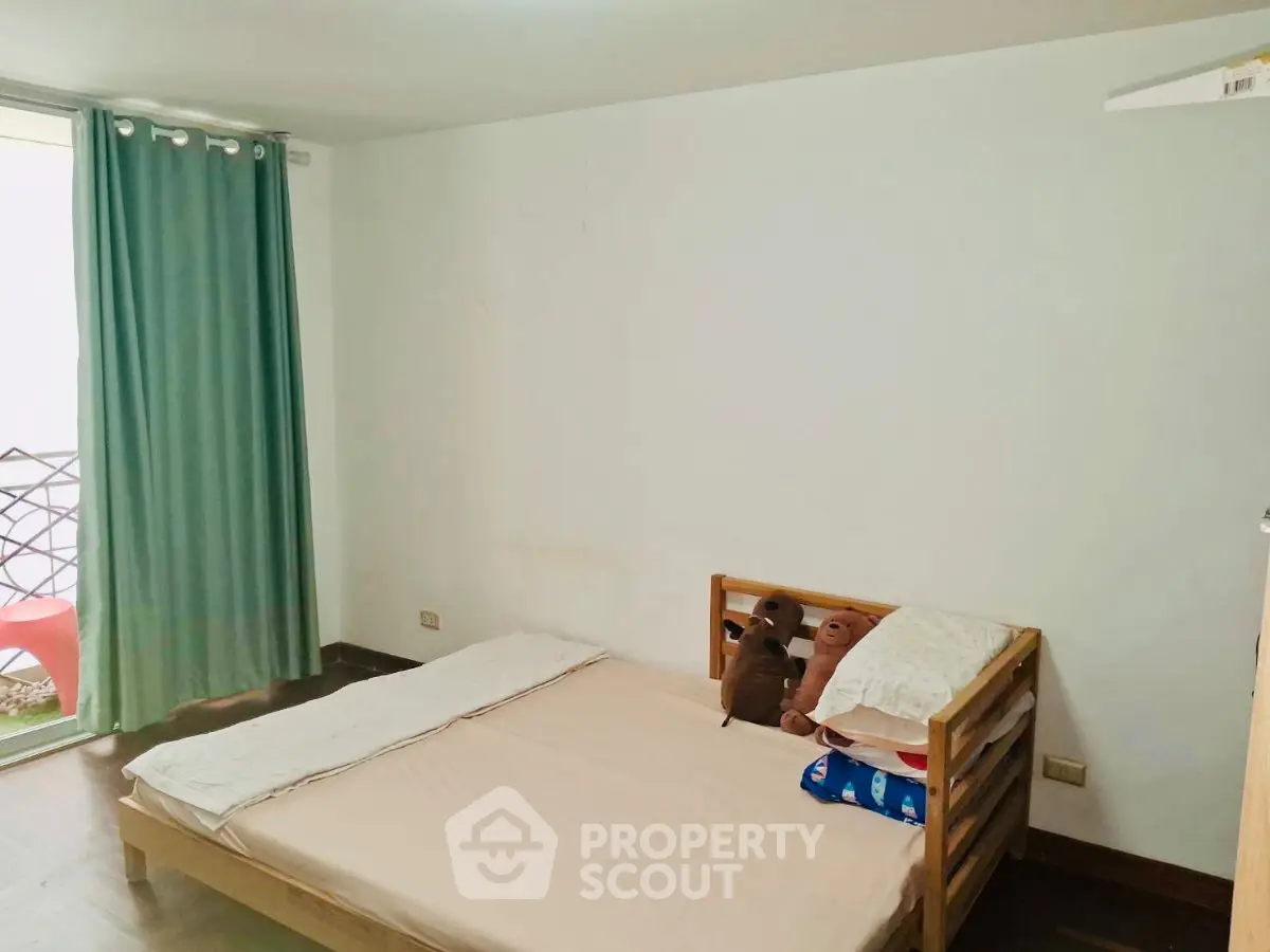 Cozy bedroom with simple decor and natural light, ideal for restful nights.