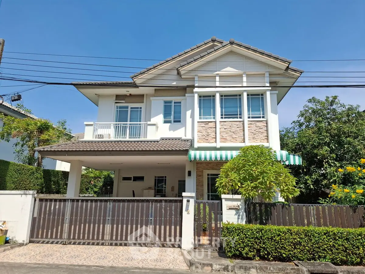 Charming two-story house with lush garden and spacious driveway in a serene neighborhood.
