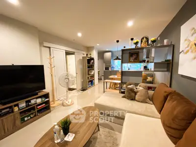 Modern living room with cozy sofa and open kitchen layout in stylish apartment
