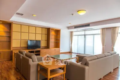 Spacious living room with modern furniture and large windows offering natural light.