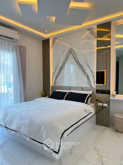 Luxurious modern bedroom with elegant marble accent wall and ambient lighting