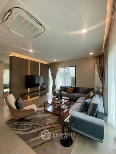 Luxurious modern living room with elegant decor and spacious seating area.