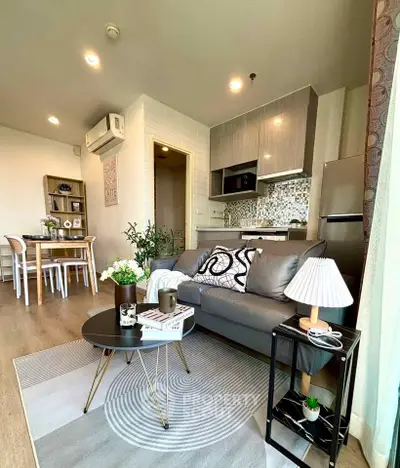 Modern living room with stylish decor and open kitchen layout in a cozy apartment.