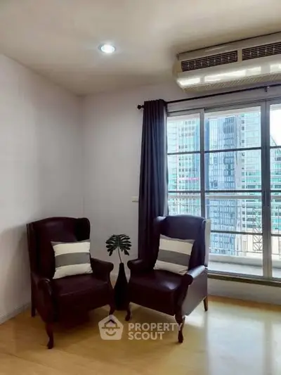 Cozy corner with elegant armchairs and city view through large window