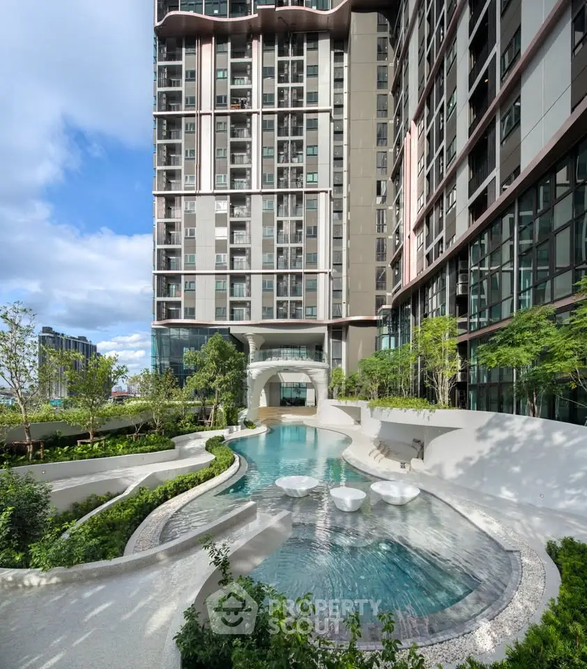 Luxurious modern apartment building with stunning pool and lush greenery