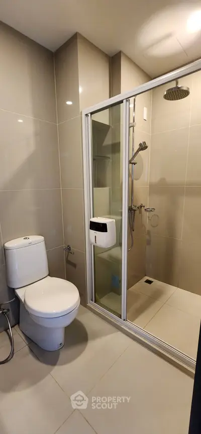 Modern bathroom with sleek shower and toilet in contemporary apartment