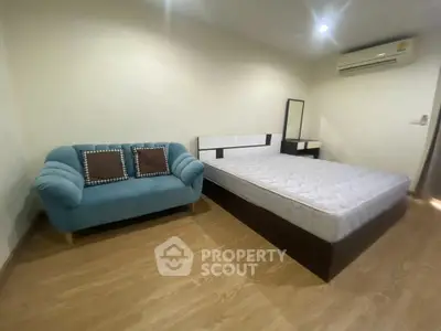 Spacious bedroom with modern furniture and air conditioning, perfect for comfort and relaxation.